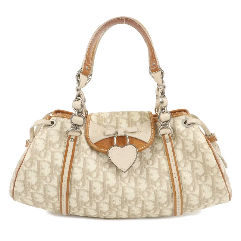 Christian Dior Saddle bags with a studded trim for a bold lookChristian Dior Trotter PVC Leather Hand Bag Beige Brown